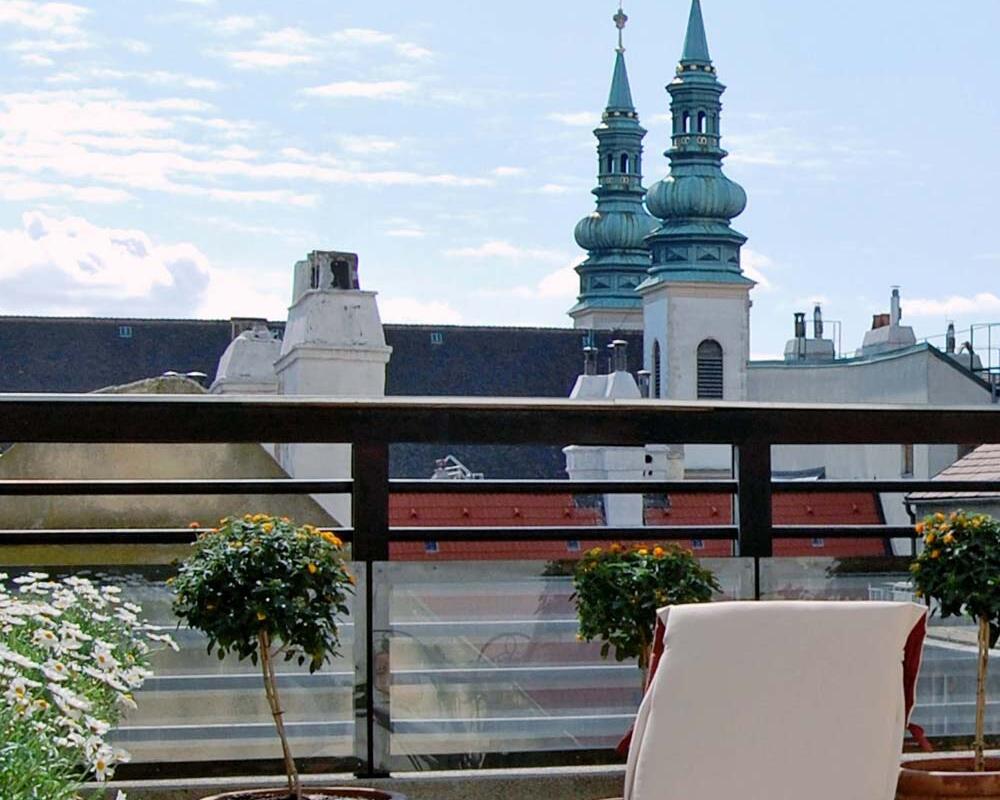 The rooftop terrace of the Hotel Kärntnerhof, with a view of the Baroque towers of the Heiligenkreuzerhof near Stephansplatz